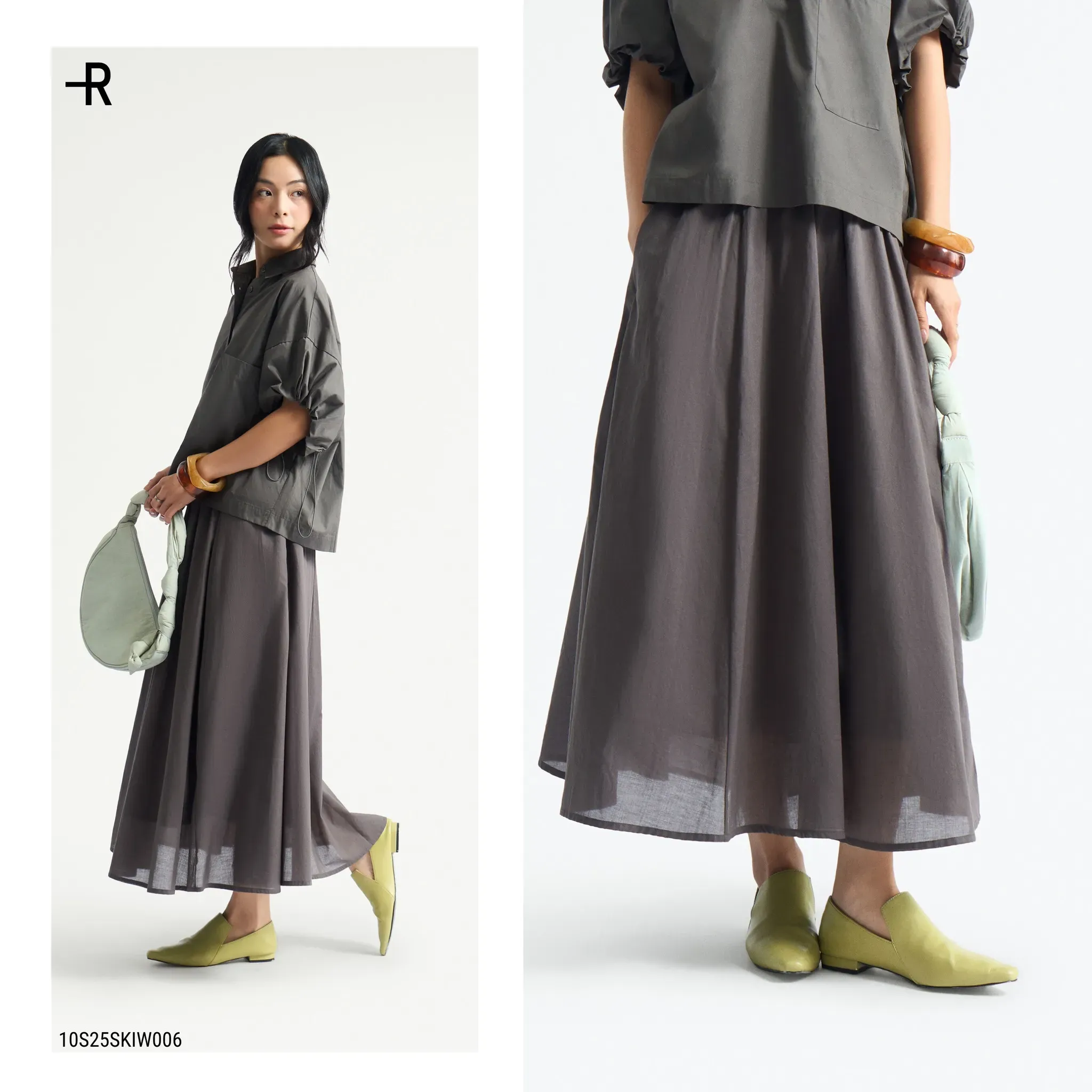 Áo sơ mi tông xám đậm và chân váy dài cùng màu, tạo nên một tổng thể trang nhã và nhẹ nhàng